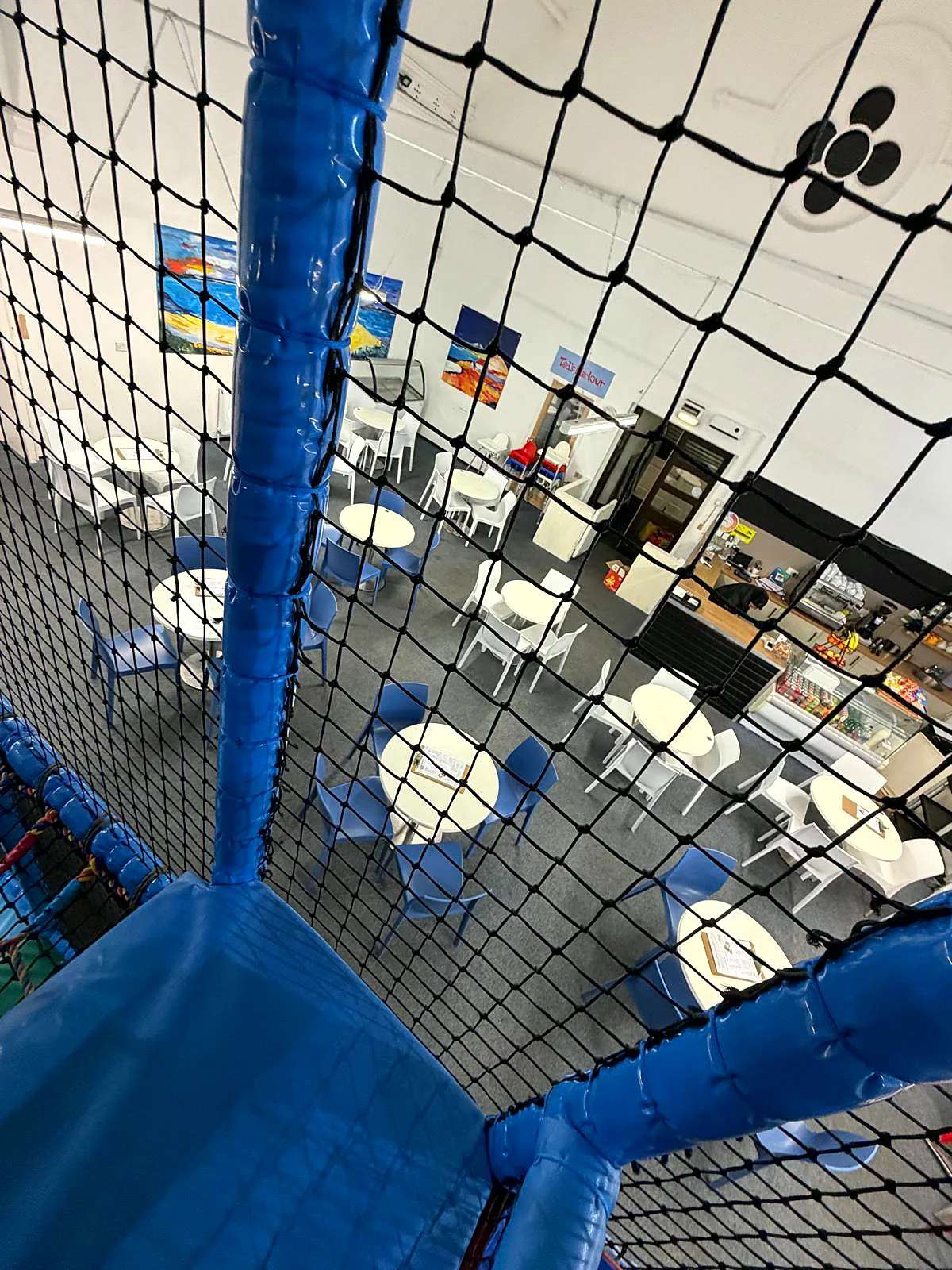 The café at Captain Ted's seen from the play frame — tables, seating and the counter