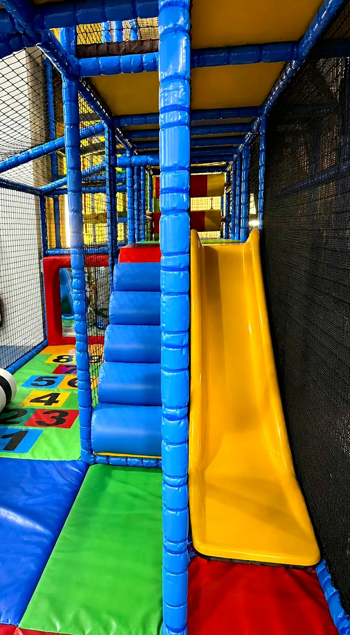 The Toddler & Baby Cove play frame at Captain Ted's — soft stairs, slide and number hopscotch mat