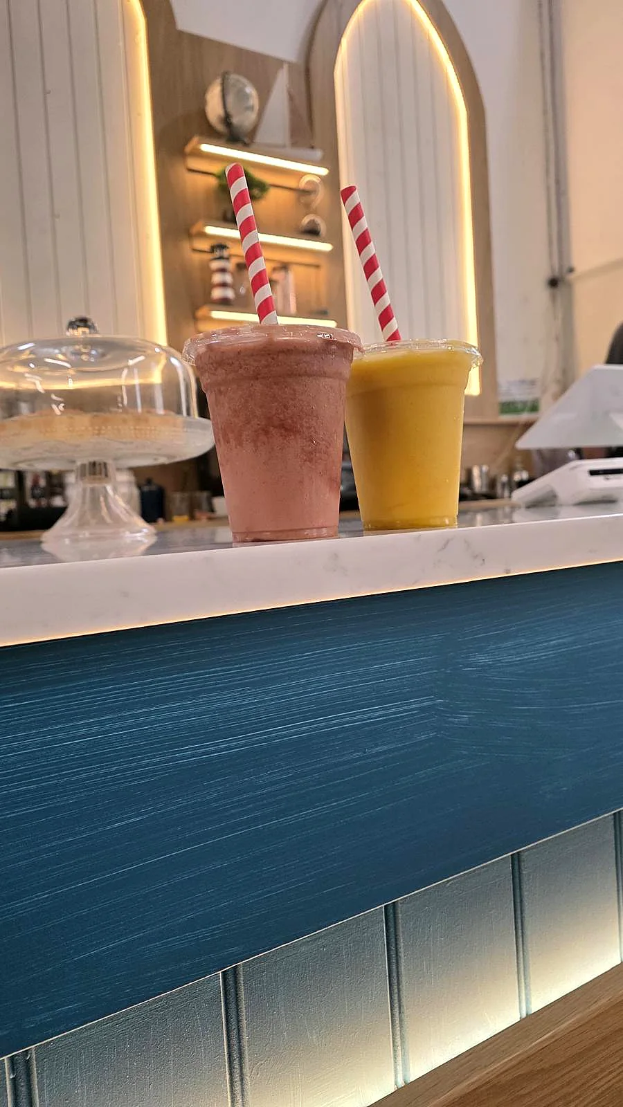 Two fruit smoothies on the caf&eacute; counter