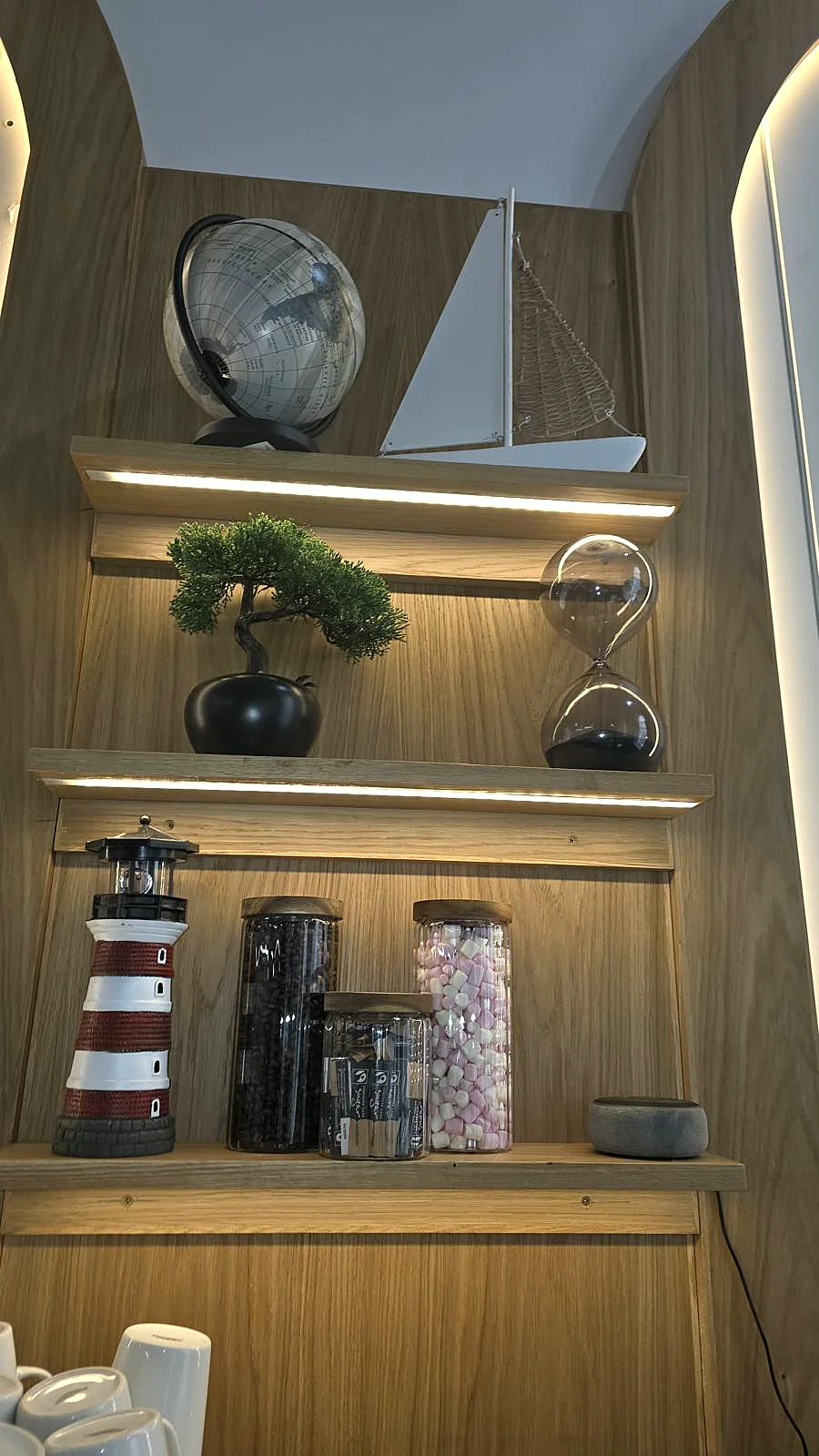 The caf&eacute; shelf with lighthouse and coffee-bean jars