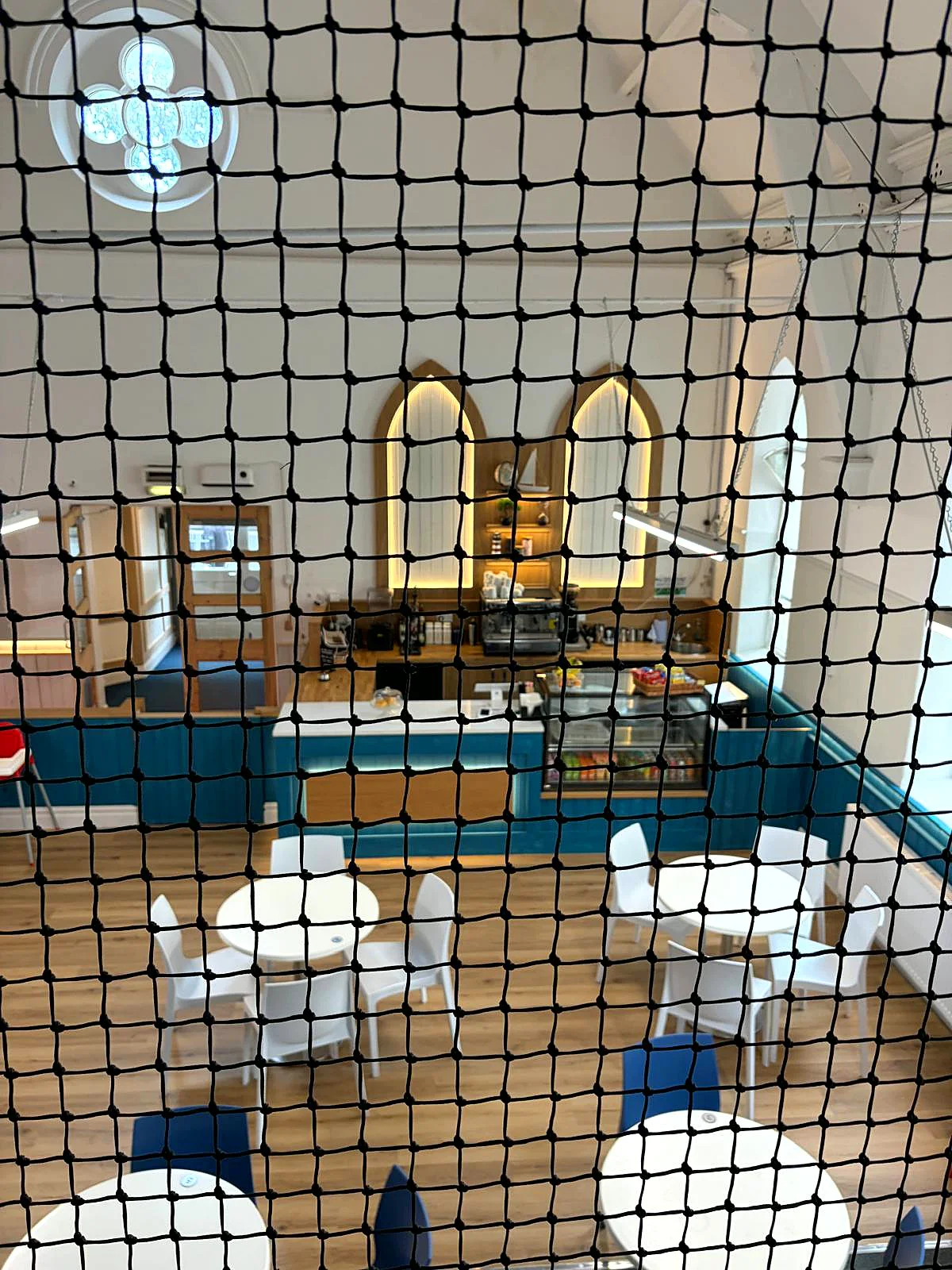 Looking down through the play frame netting to the caf&eacute; below